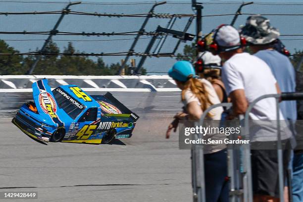 Fans looks on as Lawless Alan, driver of the AUTOParkit Chevrolet, spins into the wall after an on-track incident during the NASCAR Camping World...