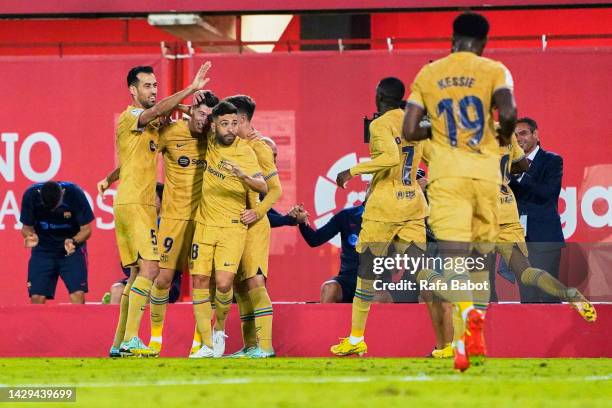 Robert Lewandowski of FC Barcelona celebrates scoring his team's first goal with teammates during the LaLiga Santander match between RCD Mallorca and...