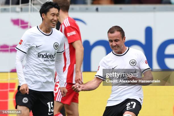 Mario Götze of Eintracht Frankfurt celebrates with team mate Daichi Kamada after scoring their sides first goal during the Bundesliga match between...