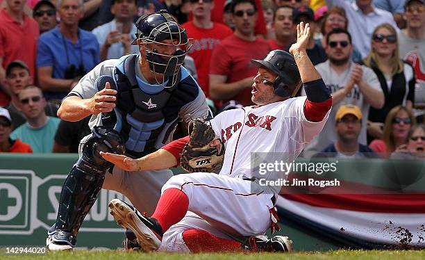 Chris Gimenez of the Tampa Bay Rays tags out Cody Ross of the Boston Red Sox at the plate in the fifth inning at Fenway Park April 15, 2012 in...