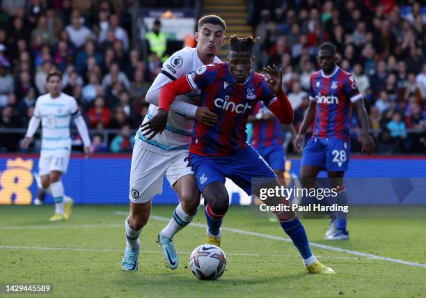 Kai Havertz of Chelsea and Wilfried Zaha of Crystal Palace battle for the ball during the Premier League match between Crystal Palace and Chelsea FC...