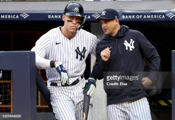 Aaron Judge and manager Aaron Boone of the New York Yankees talk before his at bat in the eighth inning against the Baltimore Orioles at Yankee...