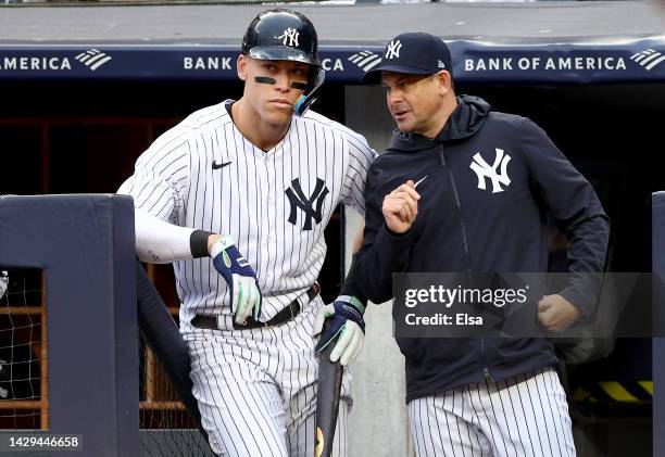 Aaron Judge and manager Aaron Boone of the New York Yankees talk before his at bat in the eighth inning against the Baltimore Orioles at Yankee...