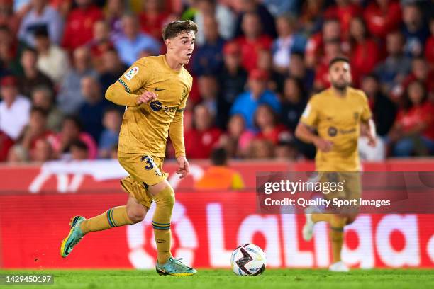 Pablo Gavi of Barcelona runs with the ball during the LaLiga Santander match between RCD Mallorca and FC Barcelona at Estadi de Son Moix on October...