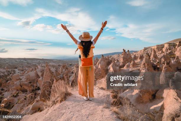traveler young girl opens her arms while watching fairy chimneys in cappadocia nevsehir , turkey - göreme-historical-national-park stock pictures, royalty-free photos & images