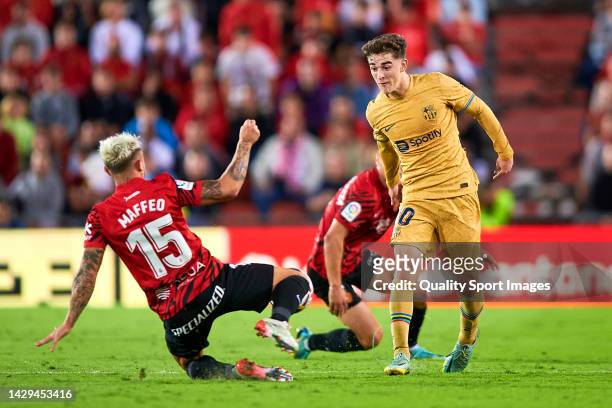 Pablo Maffeo of Mallorca competes for the ball with Pablo Gavi of Barcelona during the LaLiga Santander match between RCD Mallorca and FC Barcelona...