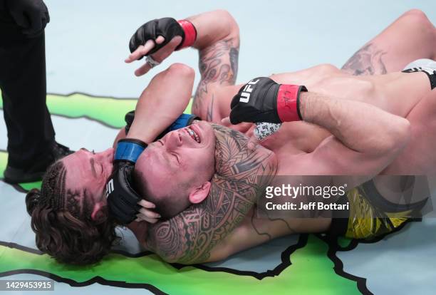 Brendan Allen secures a rear choke submission against Krzysztof Jotko of Poland in a middleweight fight during the UFC Fight Night event at UFC APEX...