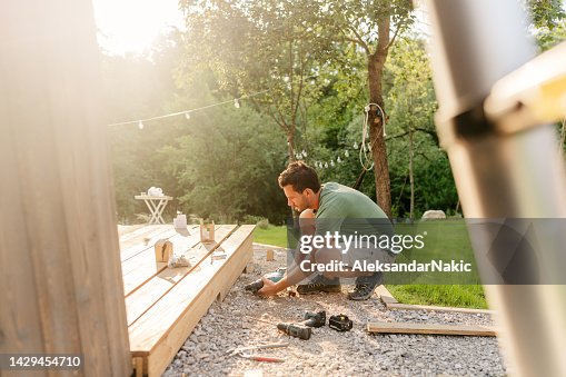 Carpenter installing decking boards Carpenter installing decking boards