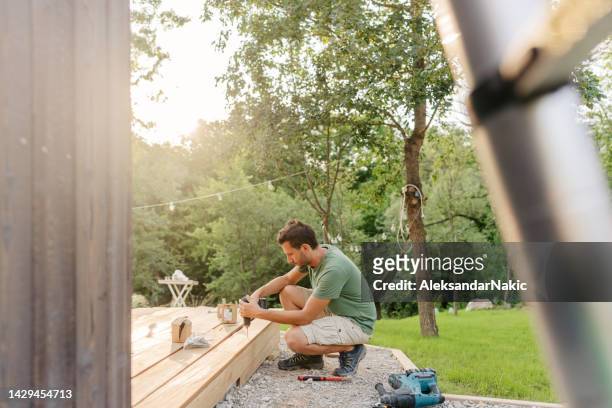 carpenter installing decking boards - floorboard bildbanksfoton och bilder