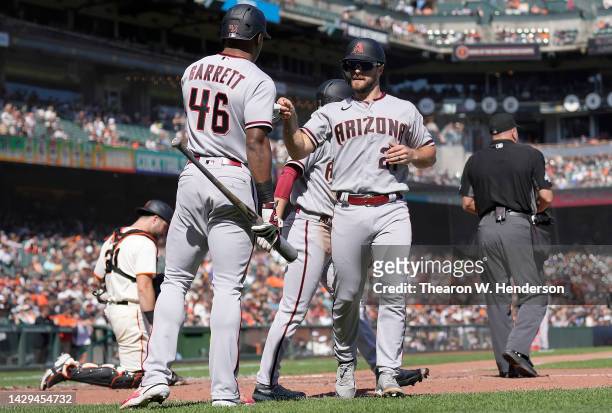 Cooper Hummel of the Arizona Diamondbacks is congratulated by Stone Garrett after Hummel scored against the San Francisco Giants in the top of fourth...