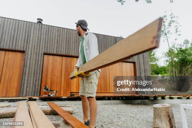 carpenter installing timber decking boards - floorboard stock pictures, royalty-free photos & images