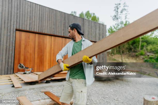 carpenter installing timber decking boards - floorboard stock pictures, royalty-free photos & images