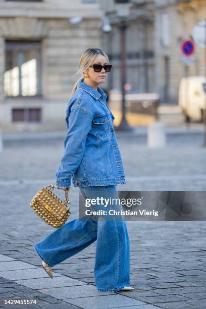 Joicy Muniz wears denim jacket Objet, jeans Lois Jeans, bag Valentino, shoes AGL, sunglasses Gigi Studios during Paris Fashion Week - Womenswear...