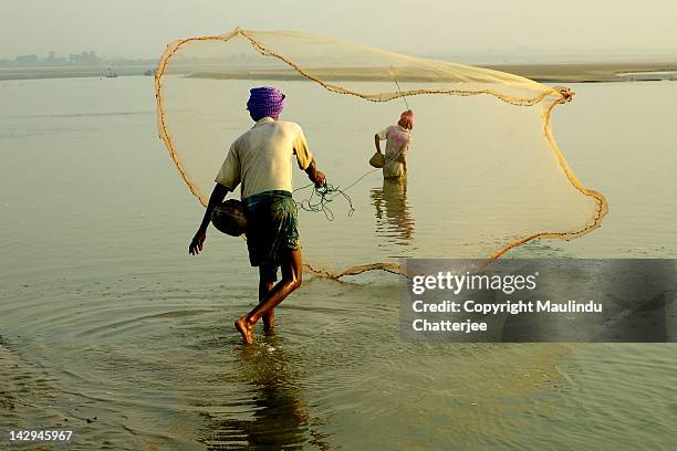 two people fishing in sea, digha - west bengal stock pictures, royalty-free photos & images