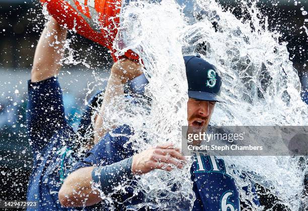 Brian O'Keefe of the Seattle Mariners is doused with water after his first MLB hit in the Seattle Mariners' 5-1 win against the Oakland Athletics at...