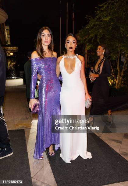 Giorgia Tordini wearing purple glitter dress and Amina Muaddi wearing white dress outside BOF 500 GALA during the Paris Fashion Week - Womenswear...