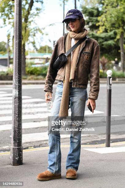 Model Rachel Marx is seen wearing a brown Carhartt jacket, brown scarf, blue jeans, brown shoes, Jil Sander black bag, black sunglasses and a blue...