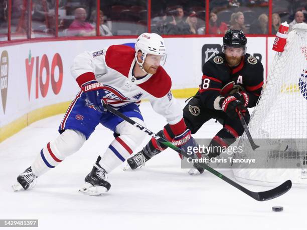 Mike Matheson of the Montreal Canadiens skates with the puck against Claude Giroux of the Ottawa Senators in the first period at Canadian Tire Centre...