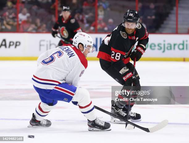 Claude Giroux of the Ottawa Senators plays the puck past Chris Wideman of the Montreal Canadiens in the first period at Canadian Tire Centre on...