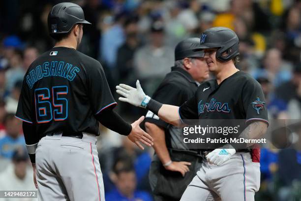 Peyton Burdick of the Miami Marlins celebrates with Jordan Groshans after hitting a two-run home run against the Milwaukee Brewers in the third...