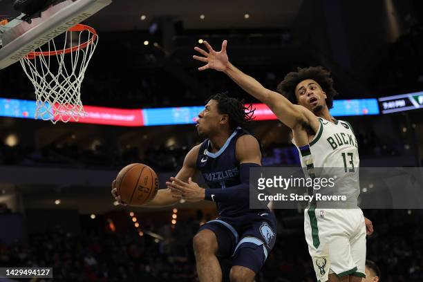 Kennedy Chandler of the Memphis Grizzlies drives to the basket against Jordan Nwora of the Milwaukee Bucks during the first half of a preseason game...