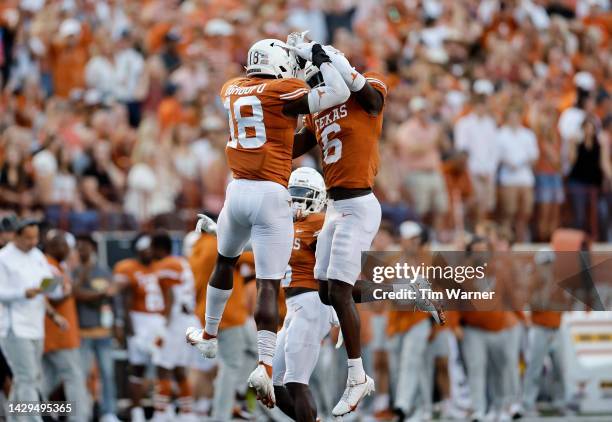 Ovie Oghoufo of the Texas Longhorns celebrates with Ryan Watts after a pass defense in the first half against the West Virginia Mountaineers at...