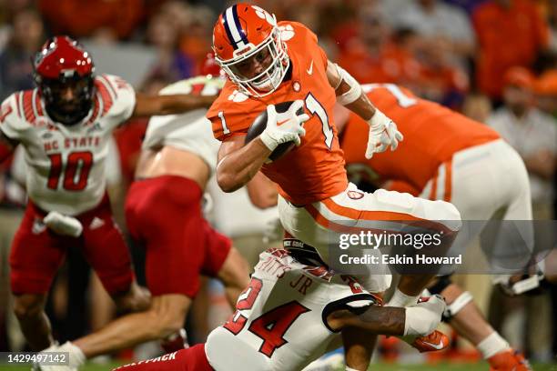 Will Shipley of the Clemson Tigers is tackled by Derrek Pitts Jr. #24 of the North Carolina State Wolfpack in the first quarter at Memorial Stadium...