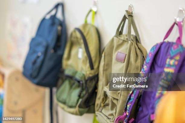 backpacks hanging - rucksack stock pictures, royalty-free photos & images