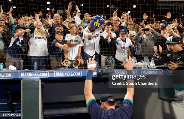 Fans cheer as Cal Raleigh of the Seattle Mariners makes his way to the clubhouse after his walk-off home run during the ninth inning against the...