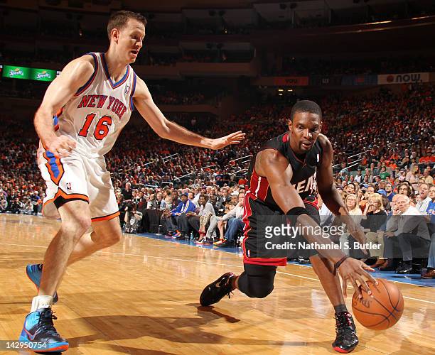 Chris Bosh of the Miami Heat controls the ball against Steve Novak of the New York Knicks during the game on April 15, 2012 at Madison Square Garden...