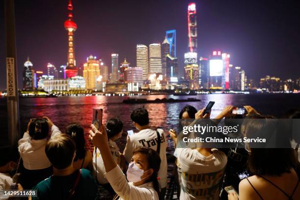 Tourists visit the Bund on China's National Day on October 1, 2022 in Shanghai, China. The weeklong National Day holiday begins on October 1.