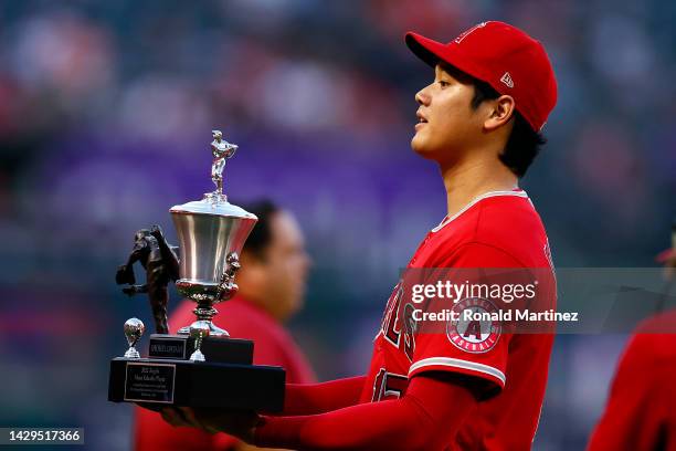 Shohei Ohtani of the Los Angeles Angels receives awards from the team before a game against the Texas Rangers at Angel Stadium of Anaheim on October...