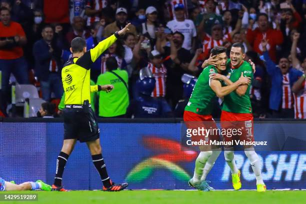 Sergio Flores of Chivas celebrates with his teammates after scoring his team's first goal during the 17th round match between Cruz Azul and Chivas as...