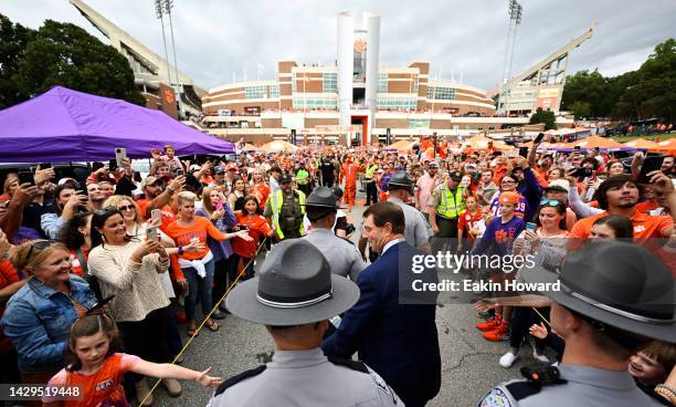 Head coach Dabo Swinney of the Clemson Tigers high-fives fans during the Tiger Walk before the game against the North Carolina State Wolfpack at...