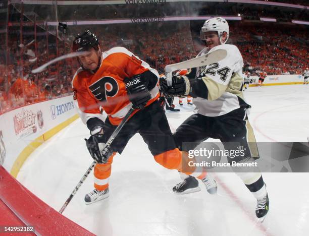 Matt Cooke of the Pittsburgh Penguins hits Pavel Kubina of the Philadelphia Flyers in Game Three of the Eastern Conference Quarterfinals during the...