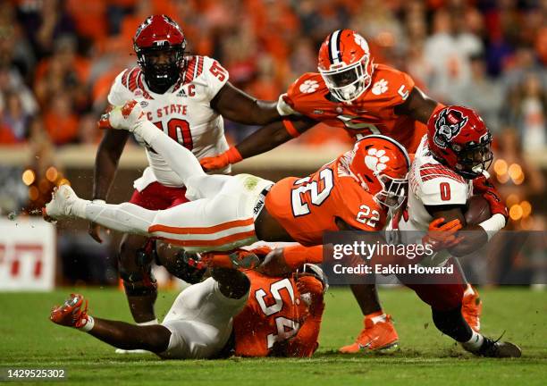 Demie Sumo-Karngbaye of the North Carolina State Wolfpack gets tackled by Trenton Simpson of the Clemson Tigers in the first quarter of the game at...