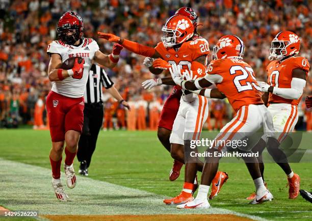 Thayer Thomas of the North Carolina State Wolfpack gets pushed out of bounds by Nate Wiggins of the Clemson Tigers in the second quarter of the game...