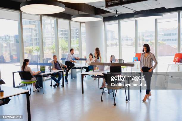 business colleagues team working behind acrylic glass sneeze by maintaining social distance in modern office during pandemic - avoidance stock pictures, royalty-free photos & images