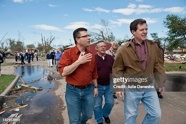 Kansas Rep. Tim Howell and Kansas Gov. Sam Brownback tour the tornado-damaged Pinaire Mobile Home Park on April 15, 2012 in Wichita, Kansas. The...