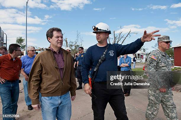 Kansas Gov. Sam Brownback and John Troyer , Captain of the Sedgwick County Fire Department, tour the tornado-damaged Pinaire Mobile Home Park on...