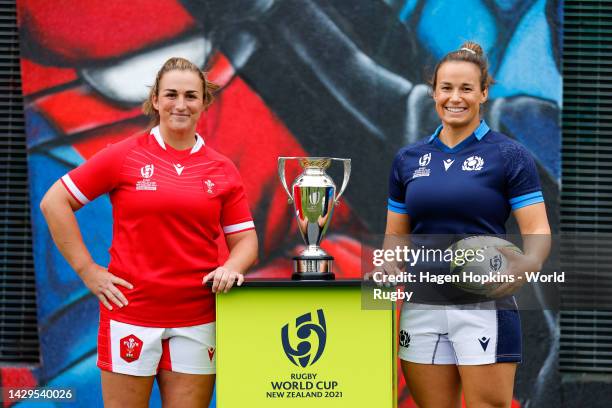 Siwan Lillicrap of Wales and Rachel Malcolm of Scotland pose with the Rugby World Cup trophy during the Rugby World Cup 2021 Captain's Photocall at...