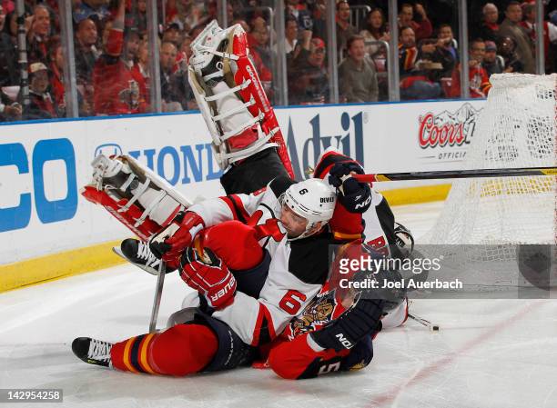 Marcel Goc of the Florida Panthers runs into Andy Greene as goaltender Martin Brodeur of the New Jersey Devils also falls to the ice in Game Two of...