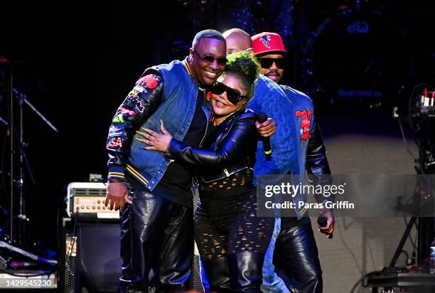 Rapper Lil Kim makes a surprise appearance with Marvin "Slim" Scandrick of 112 during the Atlanta R&B Music Experience concert at State Farm Arena on...