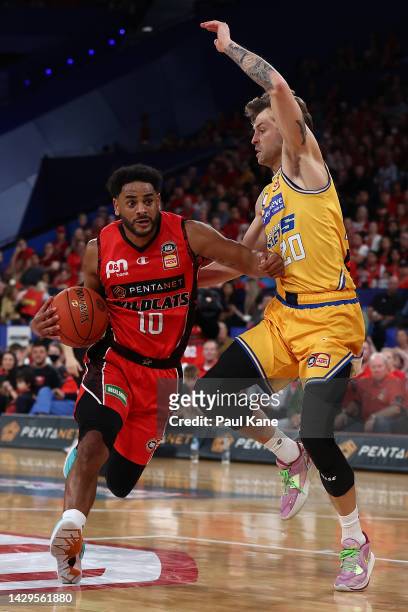 Corey Webster of the Wildcats drives to the basket against Nathan Sobey of the Bullets during the round one NBL match between the Perth Wildcats and...