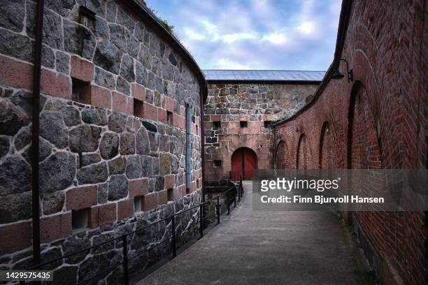 walking paht between the outer and inner protection wall at oscarsborg fortress in norway - finn bjurvoll stock pictures, royalty-free photos & images