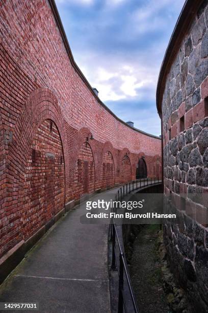 walking paht between the outer and inner protection wall at oscarsborg fortress in norway - finn bjurvoll stock pictures, royalty-free photos & images