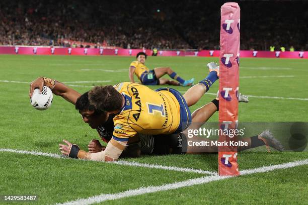 Brian To'o of the Panthers scores a try as he is tackled by Clinton Gutherson of the Eels during the 2022 NRL Grand Final match between the Penrith...