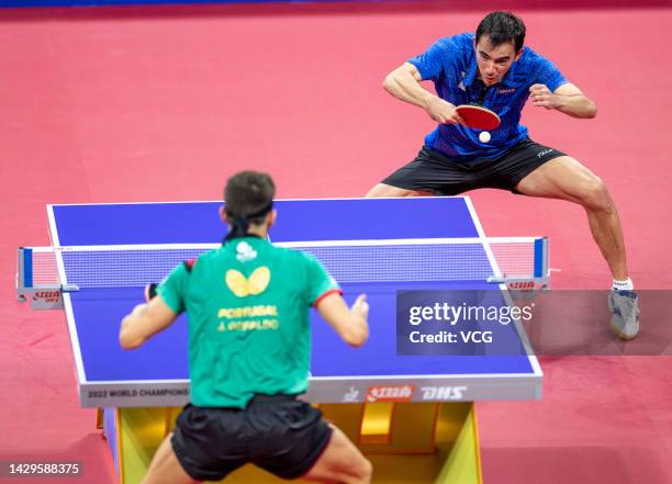 Joao Geraldo of Portugal competes against Hugo Calderano of Brazil during the Men's Group match between Portugal and Brazil on Day 3 of 2022 ITTF...