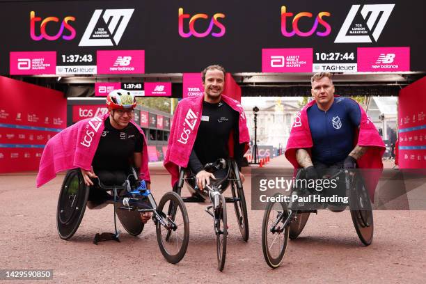 Second placed Daniel Romanchuk of United States, first placed Marcel Hug of Switzerland and third place David Weir of Great Britain pose for a photo...