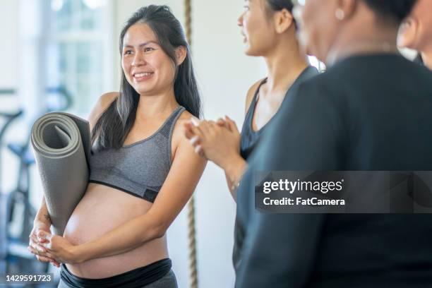 mujer embarazada que sale de la clase de yoga - belly dancer fotografías e imágenes de stock
